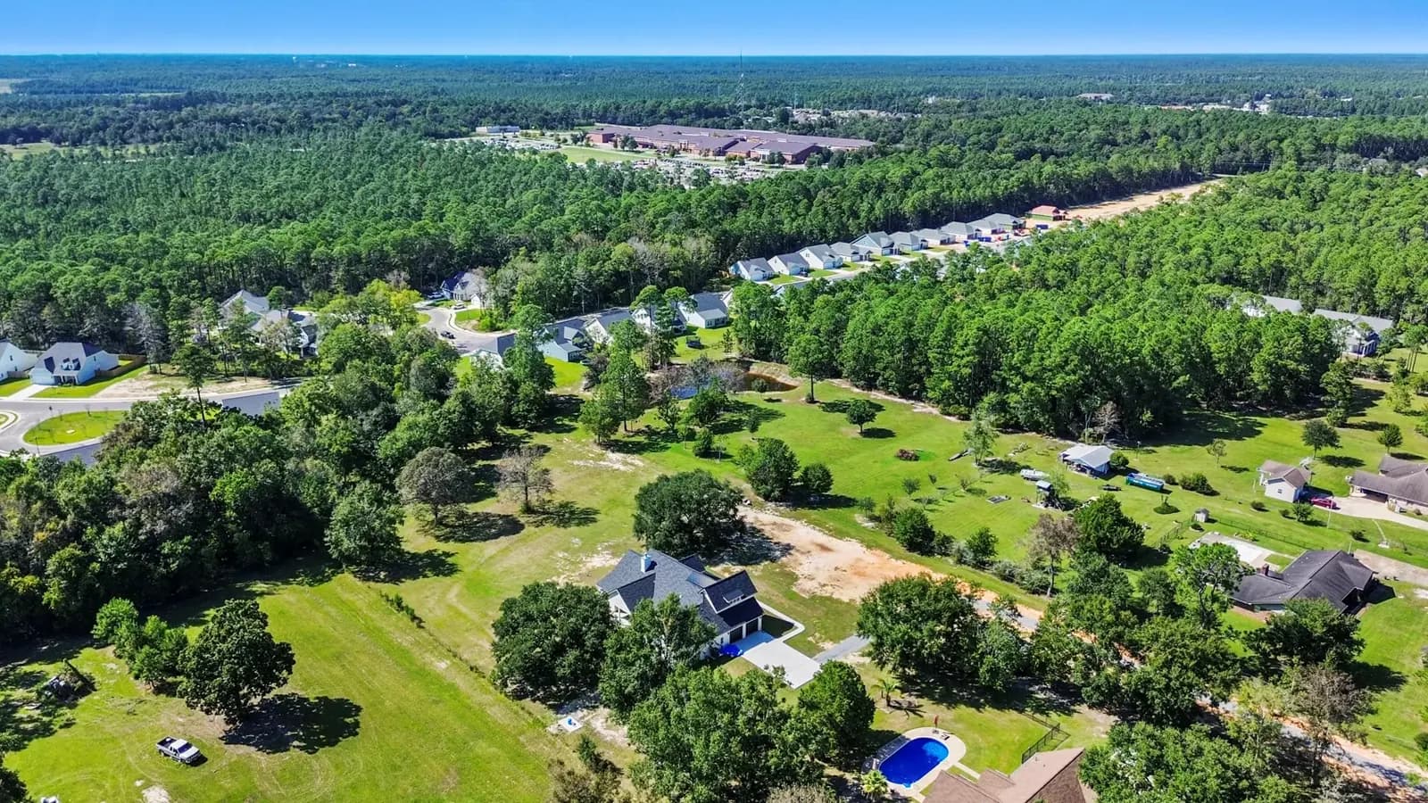 Aerial view of a wooded residential lot in Ocean Springs, MS before construction of a custom home
