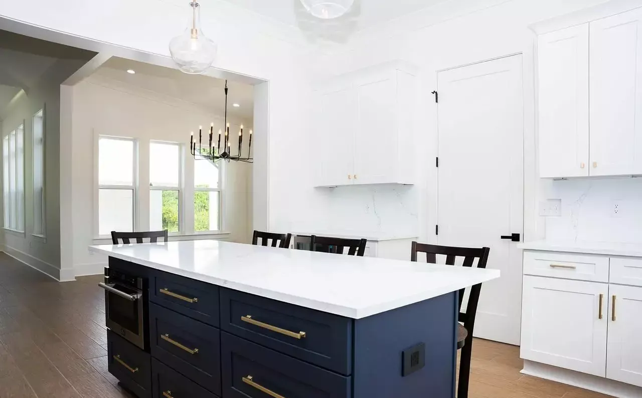 Kitchen navy island brass hardware in Pass Christian, MS