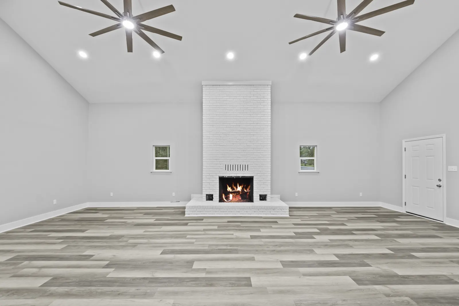 Vaulted living room with a white fireplace in a home built by Supreme Contractors Group on Portlando Circle in Biloxi, MS