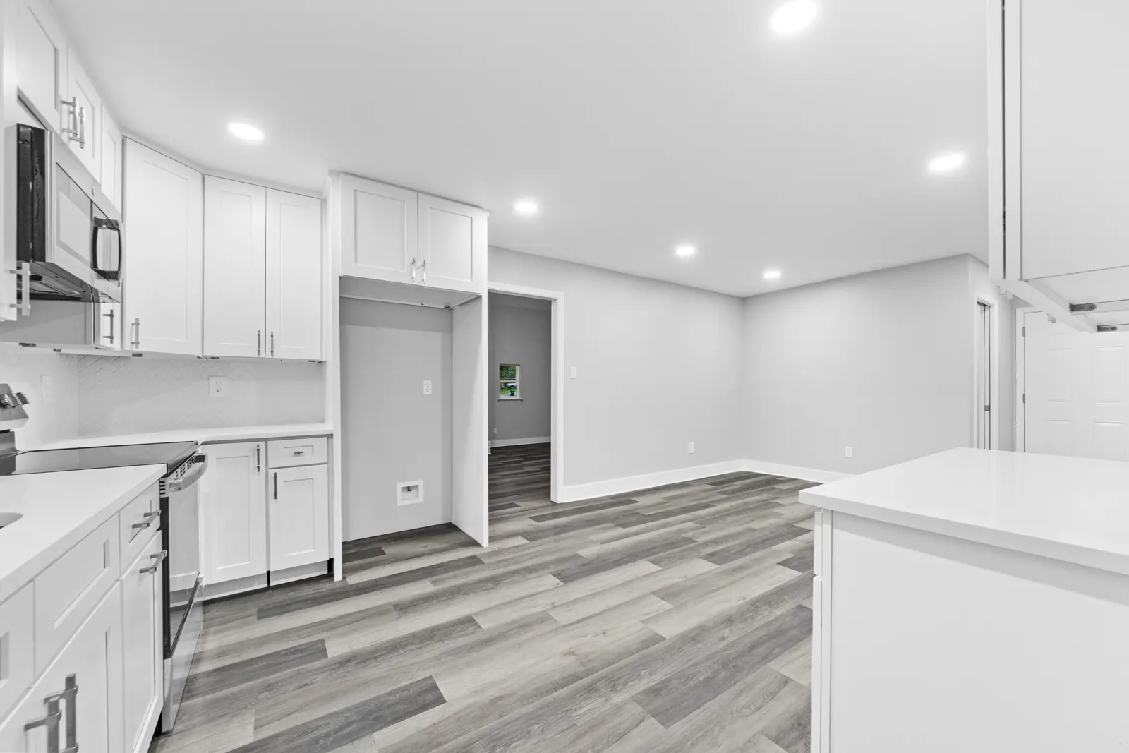 Renovated kitchen with white shaker cabinets in a Biloxi, MS home completed by Supreme Contractors Group